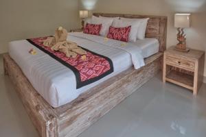 Postel nebo postele na pokoji v ubytování Gek House Ubud Bali