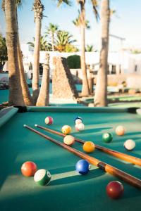 a pool table with cue balls on it with palm trees at Nautilus Lanzarote in Puerto del Carmen