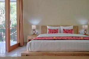 Postel nebo postele na pokoji v ubytování Gek House Ubud Bali