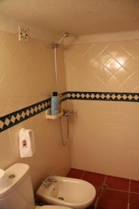 a bathroom with a white toilet and a sink at Casa Do Salgueiral in Fundão +90 photos