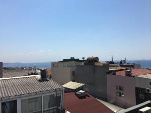 a view of roofs of buildings with the ocean in the background at Hotel Wiva in Istanbul