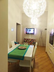 a dining room with a table and a chandelier at Bye Bye Roma Pantheon Suite in Rome