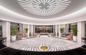 a lobby with chairs and a large ceiling at The Prestige Hotel Penang, a Member of Design Hotels in George Town