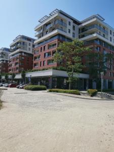 a parking lot in front of a large building at Apartments Apart 59 in Gdańsk