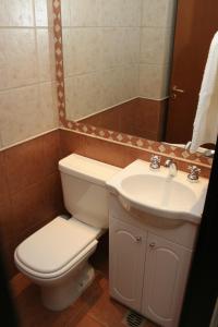 a bathroom with a toilet and a sink at Inter Apart Hotel in Salta
