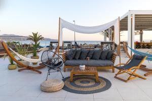 a patio with chairs and a couch and a table at Horizon Blu Boutique Hotel in Kalamata