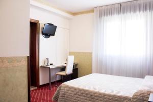 Posteľ alebo postele v izbe v ubytovaní Albergo Ristorante Belvedere