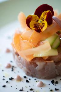 a piece of sushi with a flower on top of it at Grand Hotel Portovenere in Portovenere