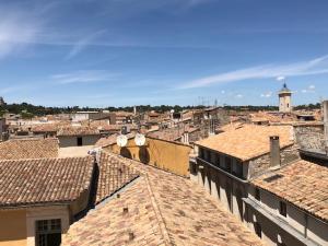 an aerial view of a city with roofs at Appartement avec terrasse panoramique au coeur de Nîmes in Nîmes +5 photos