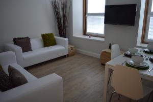 a living room with a white couch and a table at No.34 Apartment in Perth