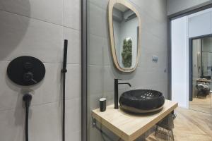 a bathroom with a black sink and a mirror at Luxury apartment JANA with private parking in Pula