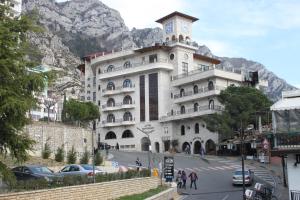 a large building with a clock tower on top of it at Hotel PANORAMA Kruje view over the castle and the old town in Krujë +34 photos