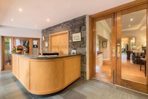 a large kitchen with a stone wall at Borrowdale Gates Hotel in Keswick