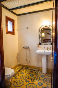 a bathroom with a sink and a toilet at Toubkal Ecolodge in Imlil