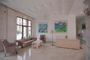 a living room with a couch and chairs and a table at Black Sea Riviera Hotel in Shekhvetili