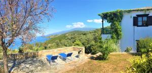 a group of chairs sitting on the side of a house at Traditional Luxury House Kedavros in Lefokastro