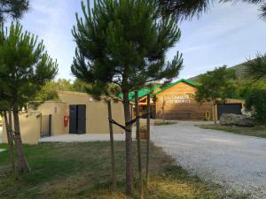 a small pine tree in front of a building at Les Chalets de Saint Maurice (Dieulefit) in Dieulefit