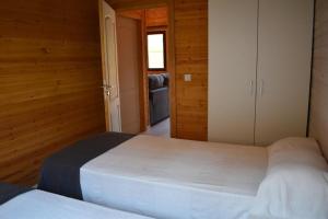 a bedroom with a white bed in a wooden room at Recinto As Casiñas in Cangas de Morrazo +47 photos