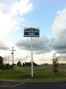 Ein Zeichen, das das erste Hamsteropfer-Gasthaus auf einer Straße liest. in der Unterkunft New Hampshire Inn West Memphis in West Memphis