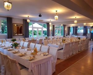 a banquet hall with white tables and chairs at Agroturystyka "U Sochy" in Ramleje