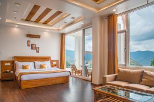 a bedroom with a bed and a couch and windows at The White Haven Homestay (Shimla) in Shimla