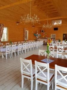 a large room with tables and white chairs at Agroturystyka "U Sochy" in Ramleje +24 photos