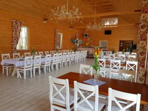 a banquet hall with white tables and white chairs at Agroturystyka "U Sochy" in Ramleje