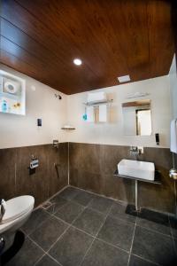 a bathroom with a toilet and a sink at Raj Residency in Bangalore