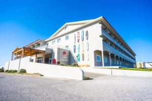a white building with signs on the side of it at Star inn Peniche in Peniche