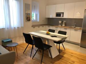 a kitchen with a table and chairs in a room at Tempus Apartment in Split