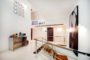 a hallway with a staircase in a house at Raj Residency in Bengaluru +9 photos