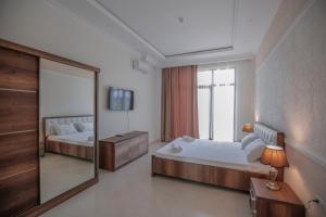 a large bedroom with two beds and a mirror at Black Sea Riviera Hotel in Shekhvetili +28 photos