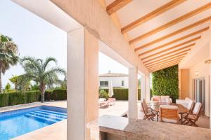 eine Terrasse mit einem Tisch und Stühlen sowie einem Pool in der Unterkunft Casa Wohra a 2.7km de la Playa in Calpe