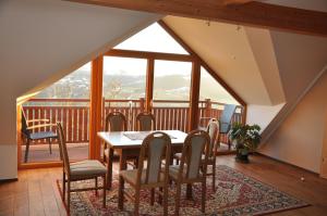 a dining room with a table and chairs on a balcony at Haaghof Ertl in Ertl