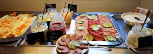 a buffet with different types of meats and vegetables at Jugendherberge Glückstadt in Glückstadt