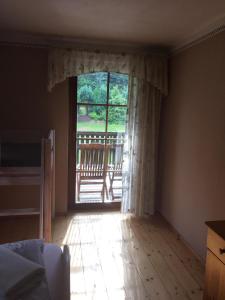 an empty room with a large window with a porch at Ferienwohnung Schulze Jonsdorf in Kurort Jonsdorf