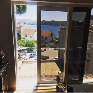 an open window with a view of the water at Laguna apartment in Tivat