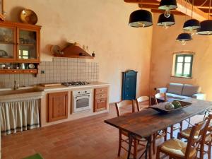 a kitchen with a table and a dining room at Apartment Nona Keka in Cres