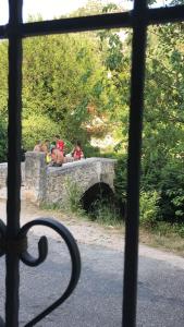 a group of people sitting on a stone bridge at Holiday Home Sarin Most in Stolac