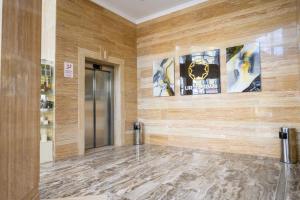 a lobby with a wooden wall and a door at URAL TAU Hotel in Ufa