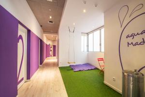 a corridor of an office with purple and green carpet at Safestay Madrid Central in Madrid