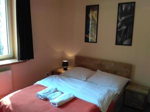a bed with two towels sitting on top of it at Akt Studio Apartment City Centre in Krakow