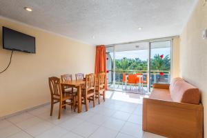 a living room with a table and chairs and a couch at Rentalmar Los Peces in Salou