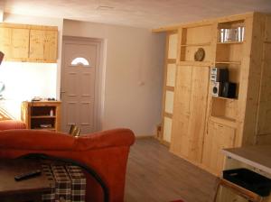 a living room with a couch and a table and a door at maison bleue in Belfort