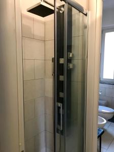 a shower with a glass door in a bathroom at Rooftop big Terrace fiera MIlano/Portello in Milan +8 photos