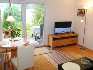 a living room with a television and a dining room table at Ferienwohnung Jachmann in Schonwald im Schwarzwald