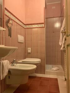 a bathroom with a sink and a toilet at Residenza D'epoca San Crispino in Assisi