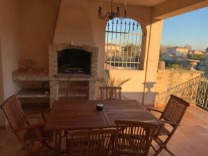 a dining room with a table and chairs and a fireplace at Appartement Salvaterra in Sauveterre