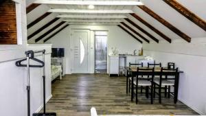 a kitchen and dining room with a table and chairs at House Mesić in Smoljanac