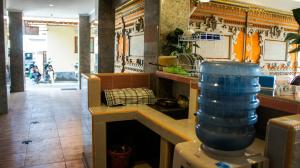 a kitchen with a counter with a large blue vase at Dana Homestay in Canggu